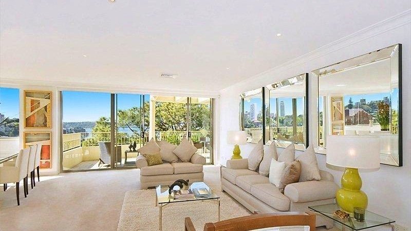 Series of framed mirrors reflecting natural light in a lounge